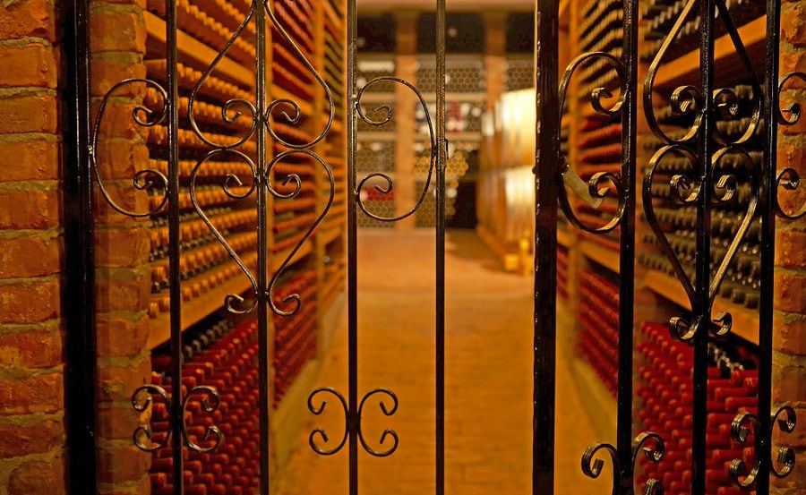 'Wine Art Estate' cellar iron netting and stacked bottles on top of each other in the walls